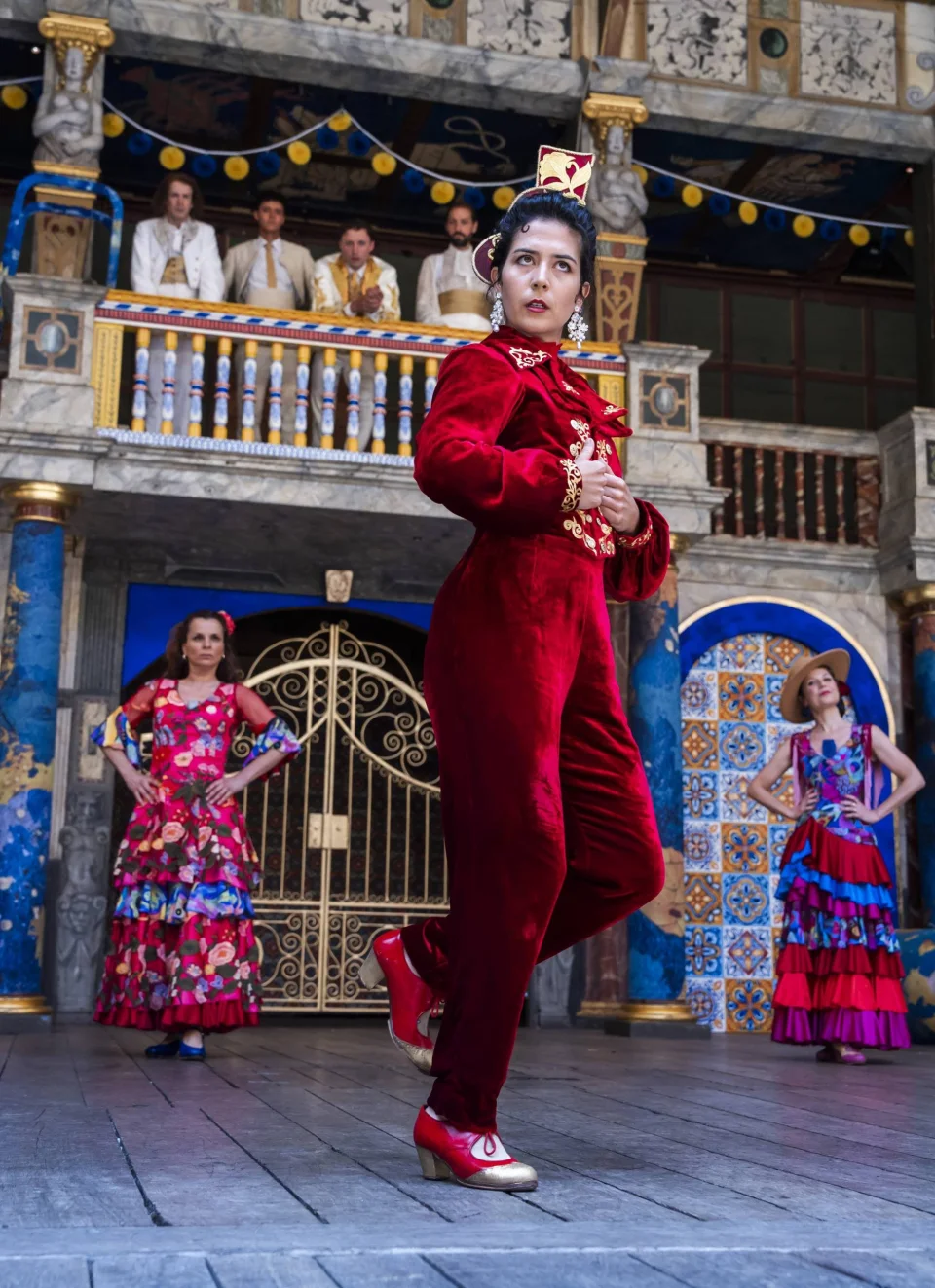 A white Spanish actor with dark hair, dressed in red velvet.